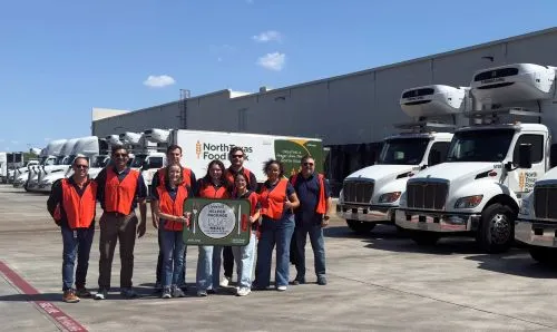 Peterbilt Employees volunteering at North Texas Food Bank with Peterbilt trucks in background