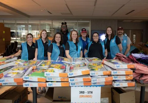 Peterbilt employees handing out backpacks and school supplies
