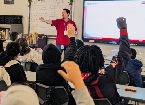 Peterbilt employee presenting to Calhoun Middle School students with some hands raised.